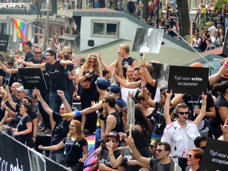 Signs with images of same sex couples and of the boat's theme