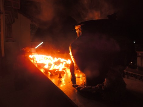 Cleaning the candles on top of a gompa